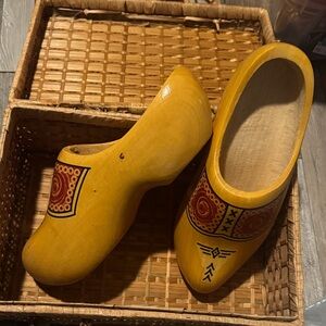 Yellow handmade Dutch wooden shoes with woven shoe case